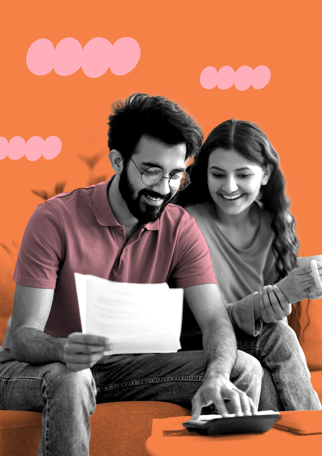 Pareja feliz sentada en sofá haciendo cuentas